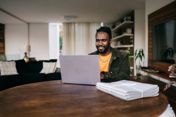 istock Young man using laptop at the desk 2192649755