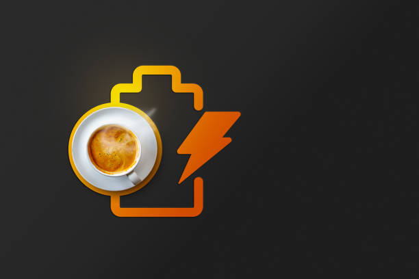 A creative representation of energy and caffeine boost featuring a steaming coffee cup paired with a glowing battery icon and lightning symbol on a modern dark background