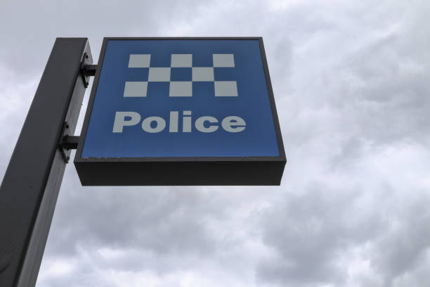 istock Blue and white Police sign, board. Against dramatic cloudy sky.  Copy space. 2192650076