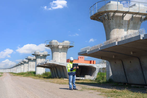 istock Asian architect engineer wearing safety uniform surveying and working at building structure checking blueprints construction site road general job details business concept architecture street 2192651176