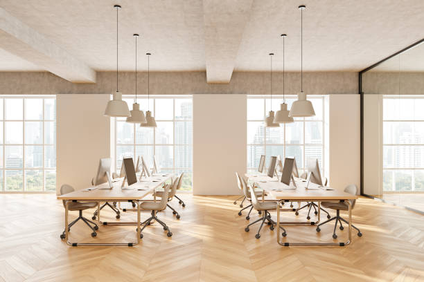 istock Office coworking interior with pc monitors in row, panoramic window 2192652426