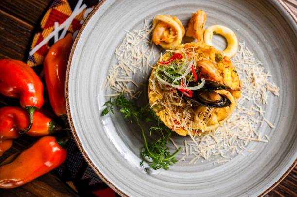 istock Gourmet seafood risotto with fresh herbs and Parmesan. 2192652468