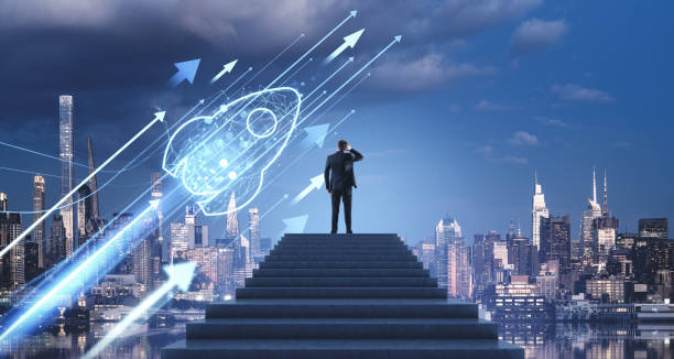 istock Businessman on stairs looking at digital rocket launch with New 2192653050
