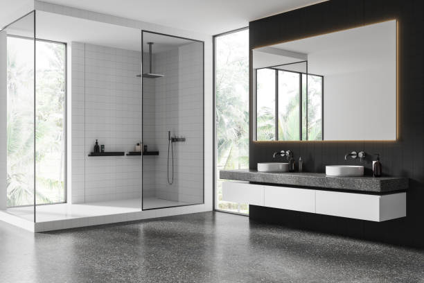 istock Modern minimalist bathroom with large shower area, black tiled walls, illuminated mirror, and sleek white floating vanity. 3D Rendering 2192653632