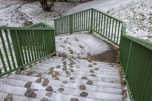 istock Snow-covered staircase with footprints leading down in winter landscape 2192654156