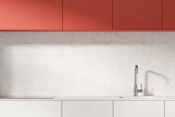 istock Modern kitchen with red cabinets and sleek sink on a light stone background. Concept of contemporary home design. 3D Rendering 2192654567