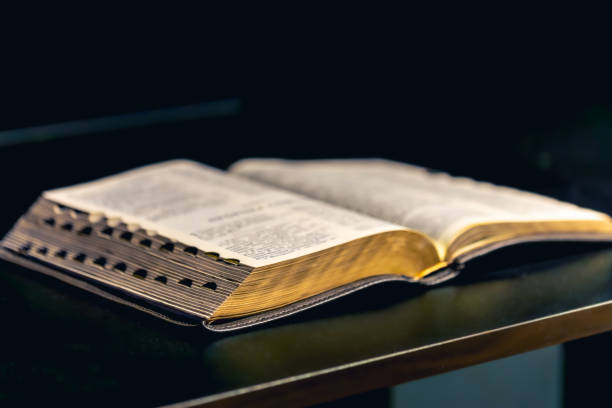 istock Open Bible on a black background. Religion concept. 2192655168