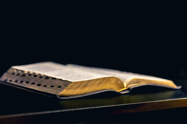 istock Open Bible on a black background. Religion concept. 2192655169