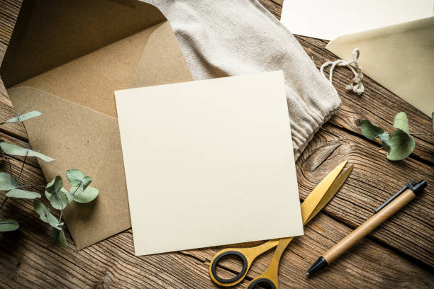 istock Empty craft greeting card and envelope shot from above on rustic wooden table. Copy space 2192655343