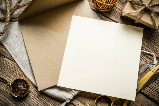 istock Blank card and envelope shot from above on rustic wooden table. Copy space 2192655345