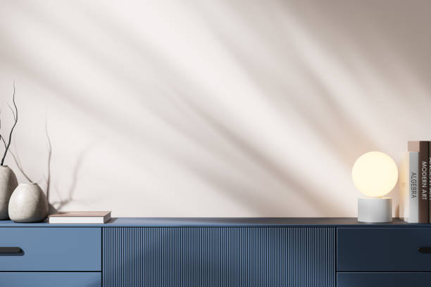 istock Minimalist home decor mockup with books, lamp, vases on blue countertop, soft light background. 3D Rendering 2192655898