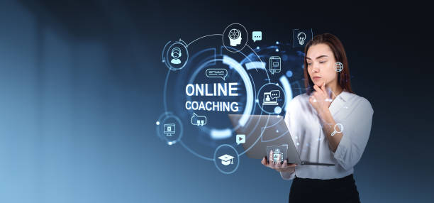 istock Woman using a laptop with various online coaching hologram icons 2192656617