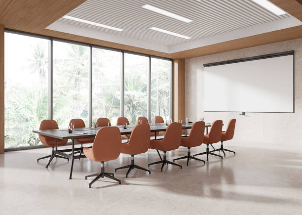 istock Conference room interior with a long table and chairs, large windows, bright light, and a minimalist style. 3D Rendering 2192656840