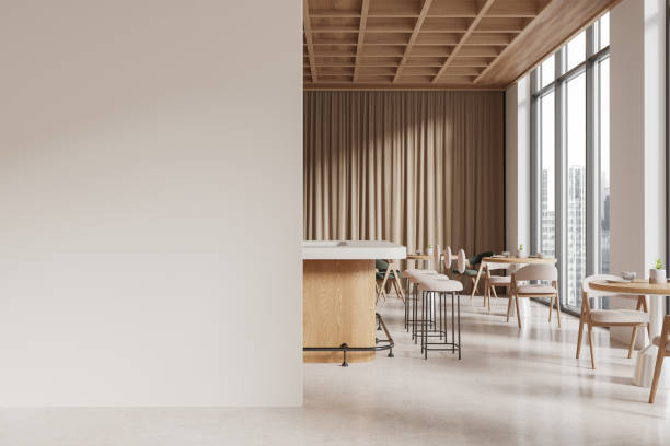istock Modern dining area with large blank wall for template, wooden bar, stools, tables, and beige curtains in a bright open interior. 3D Rendering 2192656992
