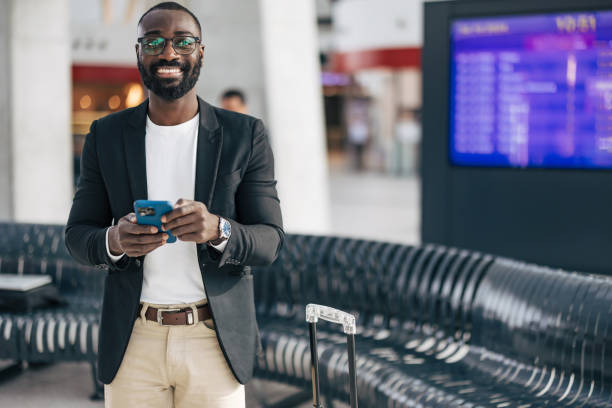 istock Businessman using smartphone in airport terminal while waiting for flight departure 2192658025