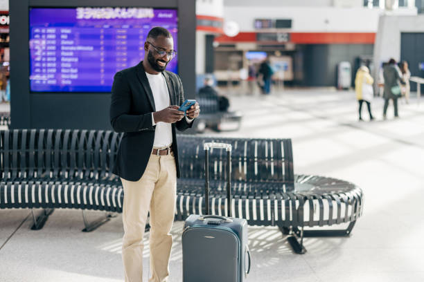 istock Businessman checking his phone while waiting at the airport terminal 2192658067