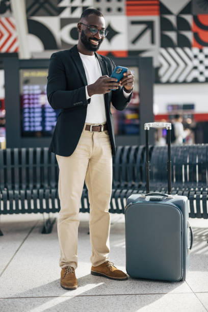 istock Businessman using smartphone while waiting at the airport 2192658073
