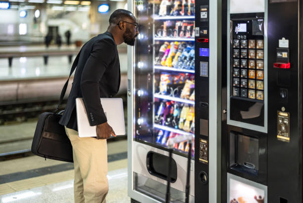 istock Businessman choosing a snack at a vending machine in a train station 2192658231