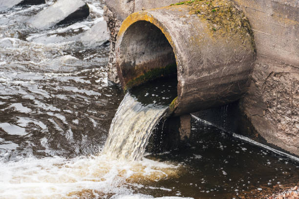 istock Dirty water flows from the pipe into the river, environmental pollution. Sewerage, treatment facilities 2192658958