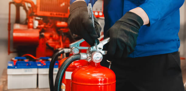 istock Engineer checks fire extinguisher in fire control room to ensure safety. When an emergency occurs 2192659214