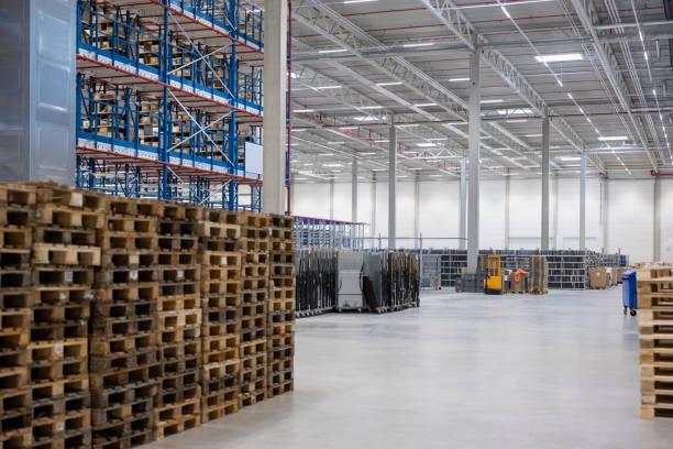 istock Modern warehouse interior with stacks of wooden palettes 2192659549