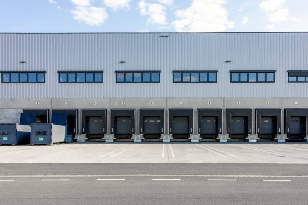 istock Cargo bays in distribution warehouse with sliding shutter doors 2192659553