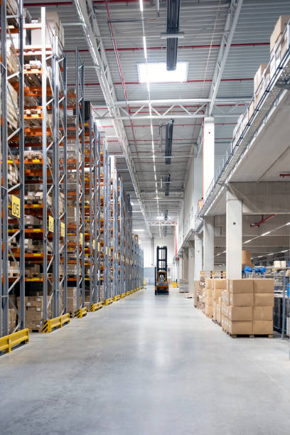 istock Organized warehouse aisle with forklift and storage racks 2192659961