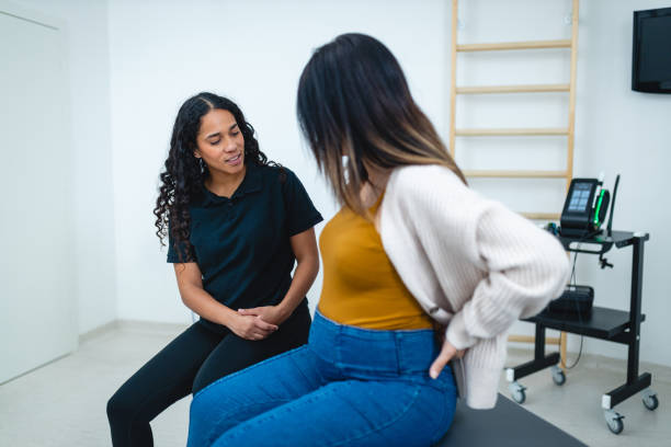 istock Hispanic Physiotherapist Assisting Patient in Clinic 2192660043