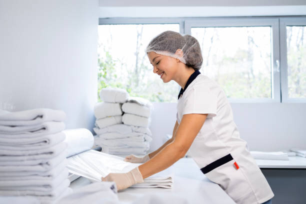 istock Lundry worker packing clean and ironed towels. 2192660257