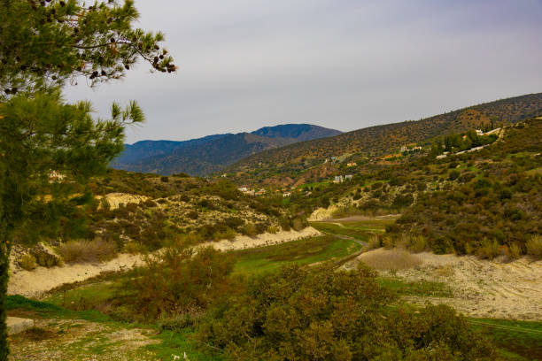 Serene photo capturing a Cypriot mountain vista with a clear sky, few clouds, and limited vegetation, showcasing the island's natural beauty