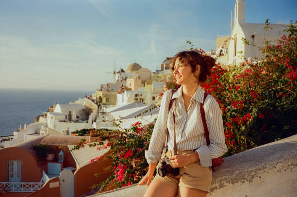Woman exploring Santorini island during trip to Greece