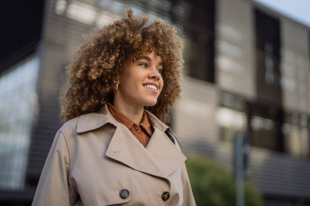 istock Beautiful woman walking outdoors looking way  and smiling 2192665989