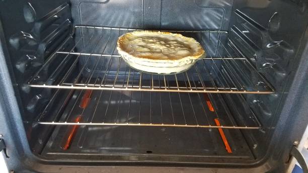 istock Homemade Apple Pie Cooking in the Oven 2192667331