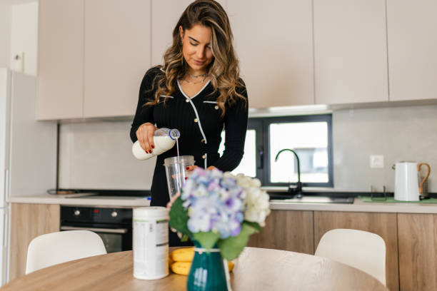 istock Woman preparing protein smoothie shake at home at morning 2192667461