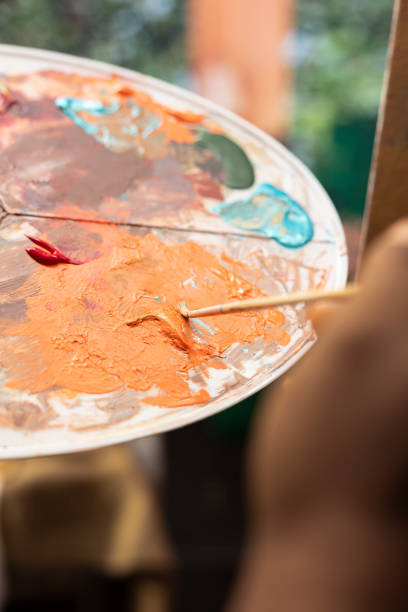 istock Confident painter mixing different watercolors on palette to create perfect dye 2192667524