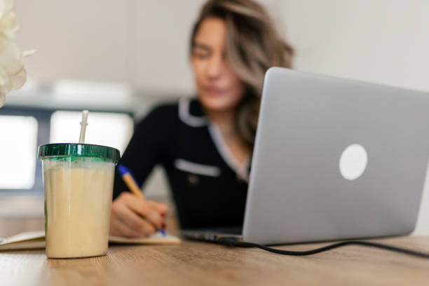 istock Woman working on her laptop and drinking protein smoothie shake 2192667566