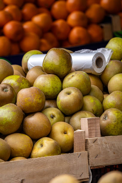istock Apples and oranges displayed on a market stall 2192667688