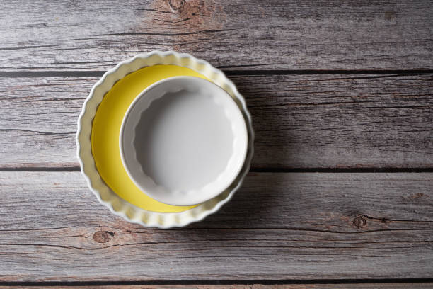 two pie mould form a crescent shape  on wood background