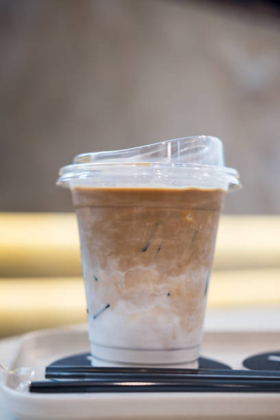 istock Iced latte with milk in a clear plastic cup on a white wooden tray 2192670407