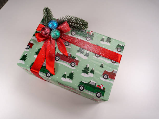istock Colorful holiday gift box decorated with festive ornaments and greenery 2192671123