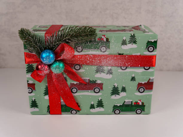 istock Festively wrapped gift box with Christmas design and red ribbon 2192671167