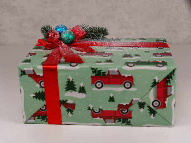 istock Festively wrapped gift box with holiday themed decorations indoors 2192671232