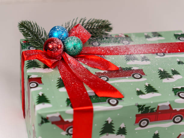istock Unique holiday gift wrapped in festive paper with decorations and bow 2192671266