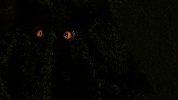 istock 3d render of spooky eyes looking through garden growth 2192672538