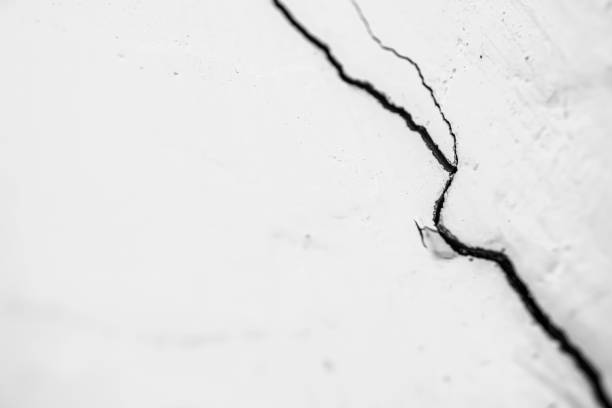 istock Cracked white walls caused by earthquake or other disaster 2192672594