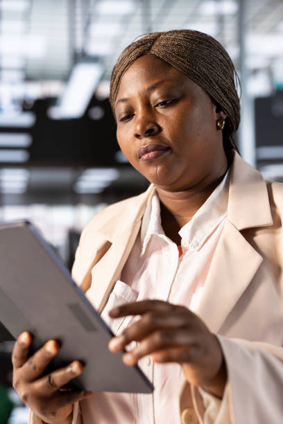 istock Accountant in busy modern startup agency inputting financial figures on tablet 2192673913