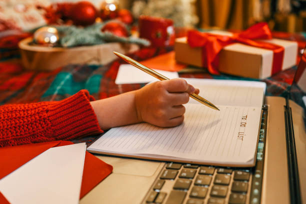 istock Child writes in notebook, Christmas mood 2192675547