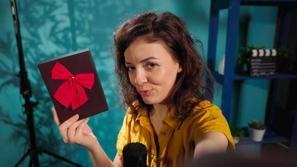 istock Joyful content creator holding present box, excited to do giveaway, POV 2192678345