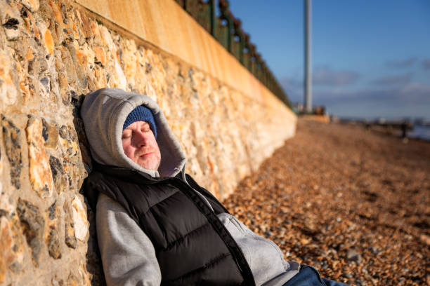 istock Homeless man sleeping rough on the beach 2192678375