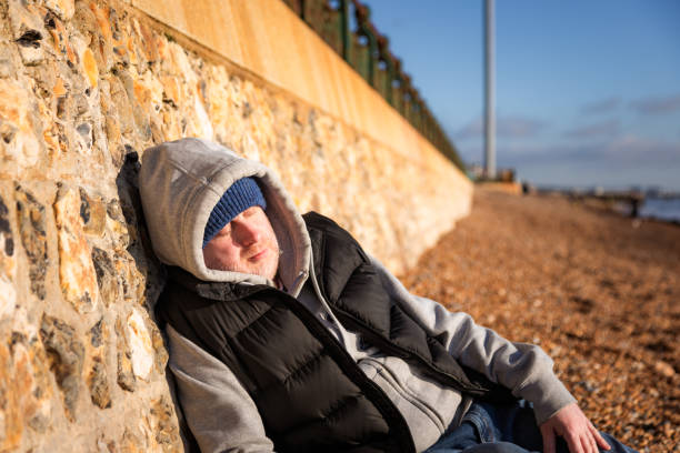 istock Homeless man sleeping rough on the beach 2192678402